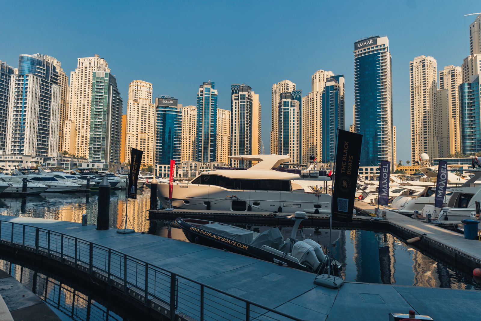 Yachts berthed beside towers at Dubai Marina